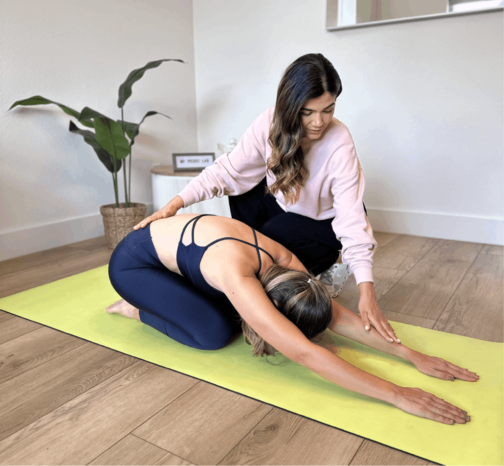Healthcare professional caring for pregnant woman in hospital bed